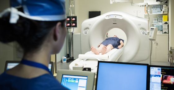 Technician and patient in MRI machine.