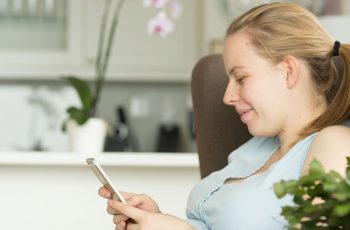 Pregnant woman using phone