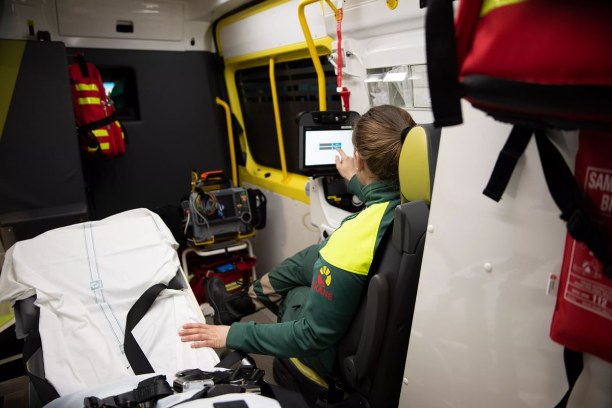 Ambulance worker using screen in the back of an ambulance.
