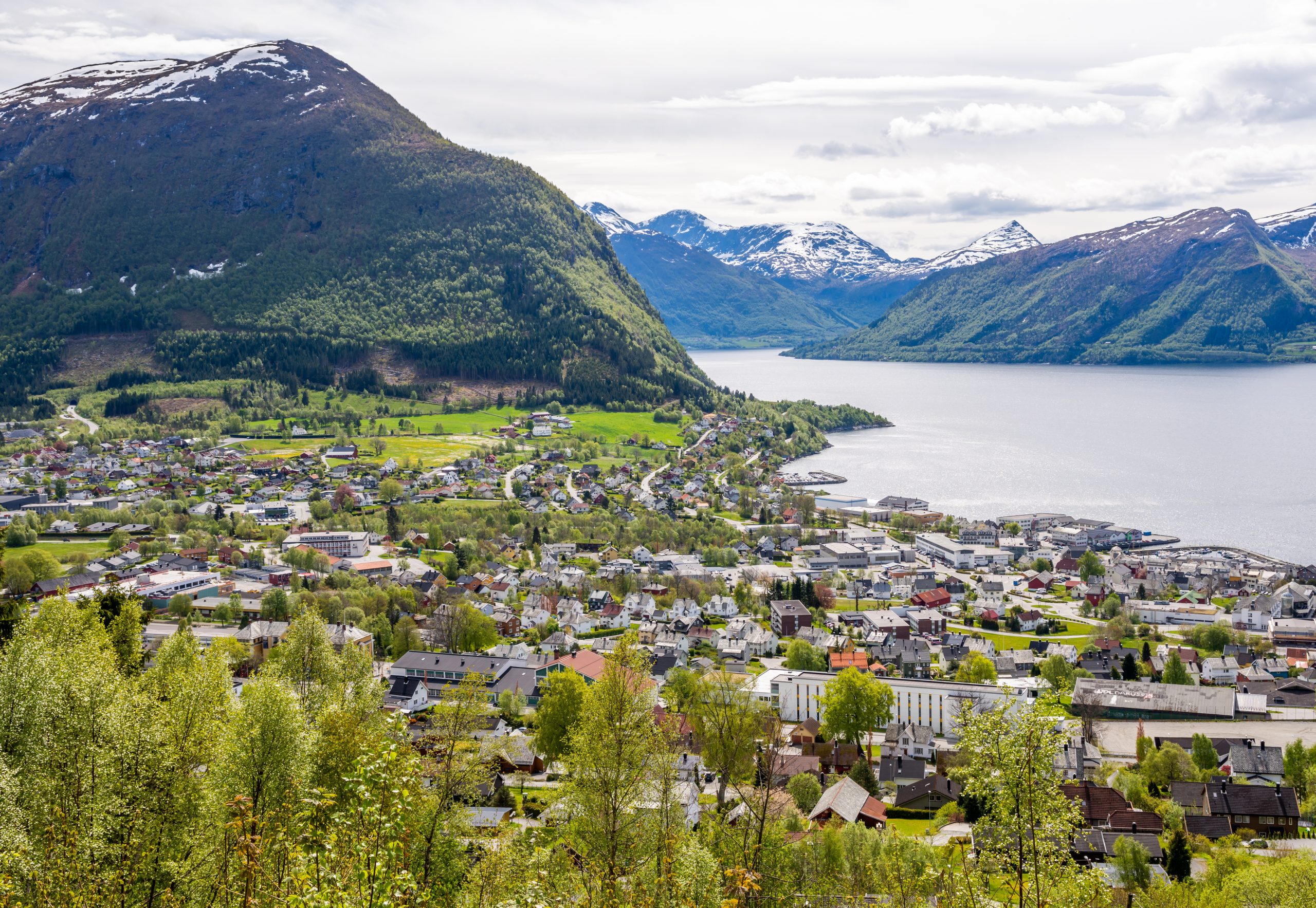 The city centre of Volda, Norway. Water and mountains in the background.